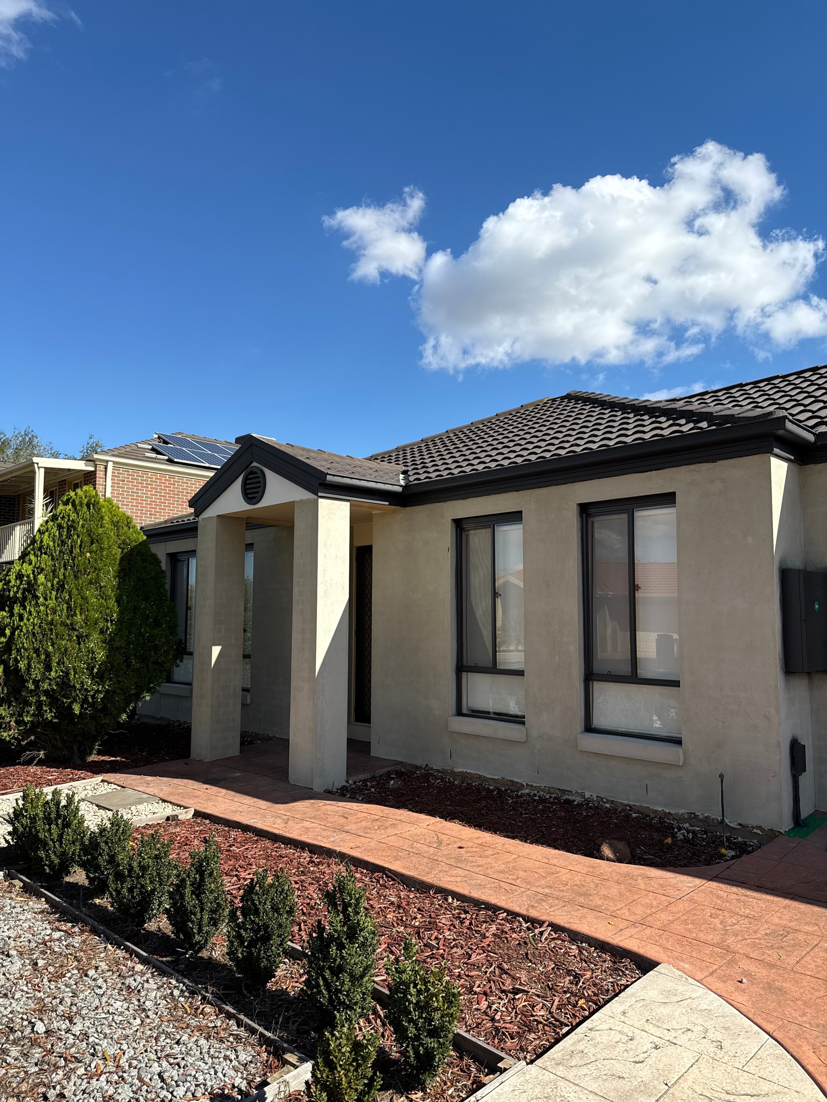 Rendered brick home with cream finish
